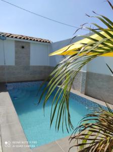 a palm tree in front of a swimming pool at La Silvita - Casa de playa in Los Órganos
