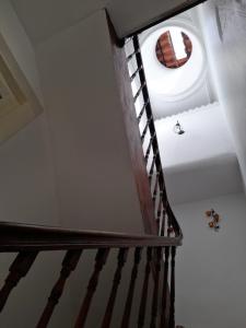 a staircase in a house with a round window at Ninho do Corvo in Torre de Moncorvo