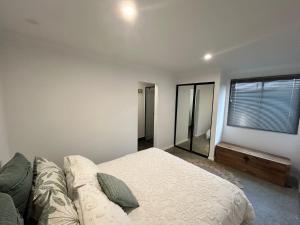 a bedroom with a bed and a couch and a window at 17 Cooyou Close in Exmouth