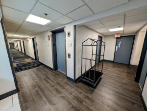 a hallway of an office building with a stair case at La Quinta Inn by Wyndham Chicago Willowbrook in Willowbrook