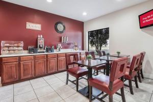 a restaurant with a table and chairs and a counter at Red Roof Inn Richmond, KY in Richmond