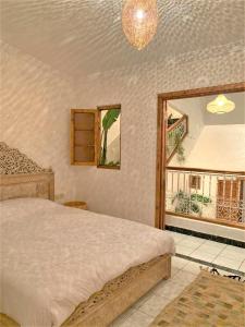 a bedroom with a bed and a window at Riad with 3 Swimming Pools in Marrakesh