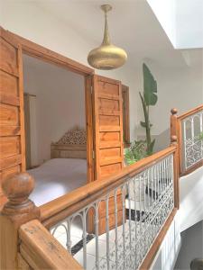a bedroom with a bed on a wooden balcony at Riad with 3 Swimming Pools in Marrakesh