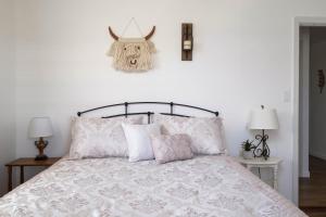 a bedroom with a bed with pink and white pillows at The Country Escape in Canyon
