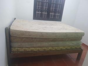two mattresses sitting on top of a bed at Casa de Temporada Próximo a Praia in Caraguatatuba