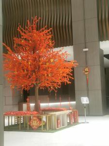 a red tree in a building with a table at K AVENUE FAMILY ROOM B09 in Donggongon