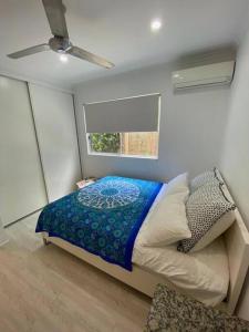 a small bedroom with a bed and a window at Trinity Beach Oasis in Trinity Beach