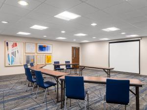 a conference room with tables and chairs and a whiteboard at Holiday Inn Express Meadville (I-79 Exit 147a), an IHG Hotel in Meadville