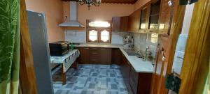 een kleine keuken met een wastafel en een magnetron bij Karainagar Holiday Home 