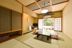 a living room with a table and chairs at Ooedo Onsen Monogatari Hotel Kinugawa Gyoen in Nikko
