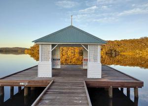 a gazebo on a dock on a lake at Walpole Rest Point Caravan Park in Walpole