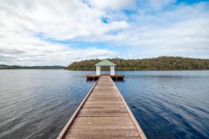 a dock in the middle of a lake at Walpole Rest Point Caravan Park in Walpole