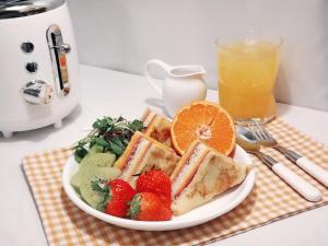 a plate of food with fruit and a drink at UH Suite Gyeongju in Gyeongju