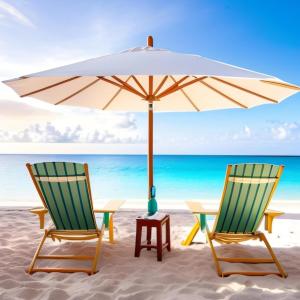 two chairs and an umbrella on the beach at lanta white sand beach guesthouse in Ban Mo Nae