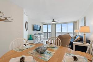 a dining room and living room with a table and chairs at Pinnacle #503 Oceanfront*Enclosed Outdoor Pool*NEW Updates!, 2022 Updates-Pinnacle #503 OceanFront*E in Myrtle Beach