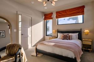a bedroom with a bed and a window and a chair at Aspects Big Sky in Big Sky