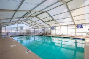 a large indoor swimming pool with blue water at Pinnacle #503 Oceanfront*Enclosed Outdoor Pool*NEW Updates!, 2022 Updates-Pinnacle #503 OceanFront*E in Myrtle Beach