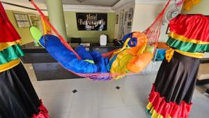 a person in a hammock in a room at Hotel Barranquilla Inn in Barranquilla
