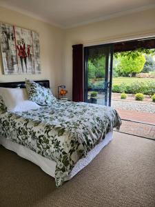 a bedroom with a bed and a large window at Woodlands in Geraldine