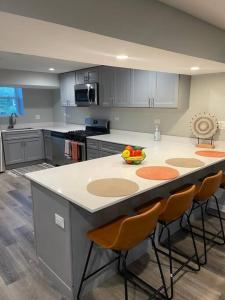 a kitchen with a island with a bowl of fruit on it at SPACIOUS & MODERN 3 BR HOME WI-Fi FREE PARKING in Chicago