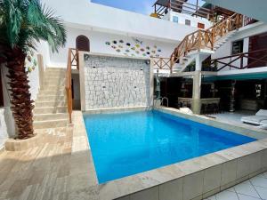 a swimming pool in the middle of a house at Hostal Ocean Pacifico in Punta Negra