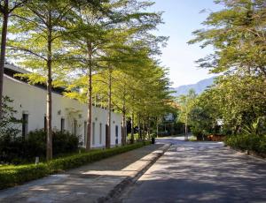 uma rua vazia com árvores ao lado de um edifício em Nha cua ca villa - Venuestay em Nam Giao