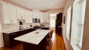 a kitchen with white cabinets and a white counter top at Perrin Place Unit 3 in Boston