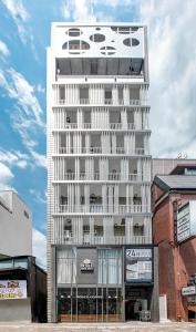 a white building with a car on top of it at Hotel Xcell 広島 流川通り in Hiroshima