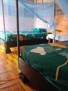 a bedroom with two bunk beds and a fan at Amfriwen Homestay in Yennanas Besir