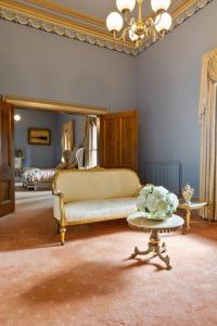 a living room with a couch and a table at Bishops Palace Ballarat in Wendouree