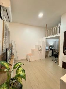 an empty living room with a staircase in a loft at Lanara House in Magalang