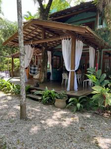 a wooden deck in front of a house at Casa da árvore em Paúba . in São Sebastião