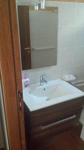 a bathroom with a sink and a mirror at Azienda Agricola Cuntarati in Bronte