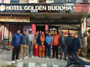 a group of people standing in front of a hotel golden budha at HOTEL GOLDEN BUDDHA in Lumbini