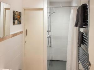 a bathroom with a shower and a glass door at Harbour Way in Ilfracombe