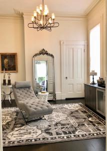 a living room with a chair and a mirror at Pacific Heights Grand Elegant Studio in San Francisco