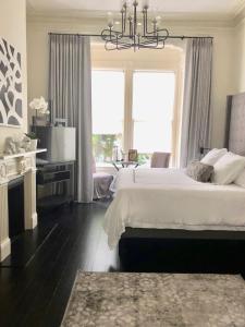 a bedroom with a large bed and a chandelier at Pacific Heights Grand Elegant Studio in San Francisco