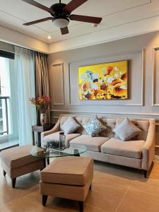 a living room with a couch and a ceiling fan at Luxury 2Bedroom Apartment with Ocean view 25th Floor in Da Nang