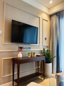 a living room with a television on a wall at Luxury 2Bedroom Apartment with Ocean view 25th Floor in Da Nang