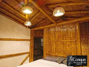 a room with a bed and two lights on the ceiling at Coaque black Mompiche in Mompiche