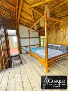 a bedroom with a bed in a straw hut at Coaque black Mompiche in Mompiche