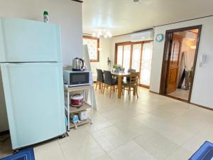 a kitchen and dining room with a refrigerator and a table at Aroha house for Foreign guests only in Seoul