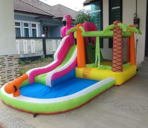 a inflatable bounce house in front of a house at Villa Tamu Dr Din - Pool OR Soopa Doopa in Rantau Panjang