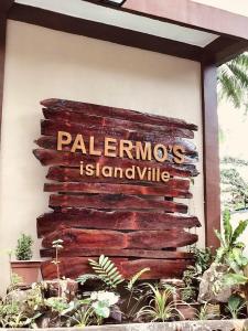 a sign for a palenmos istanbul on a wall at Palermos IslandVille in Catarman