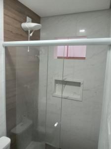 a glass shower in a bathroom with a toilet at Hotel New Space in Sao Paulo