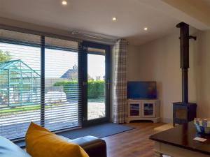 a living room with a large sliding glass door at The Stables - Uk13658 in Middleton