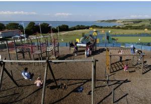 a group of children playing in a playground at 51 Oaklands caravan park dean thorness bay cowes in Porchfield