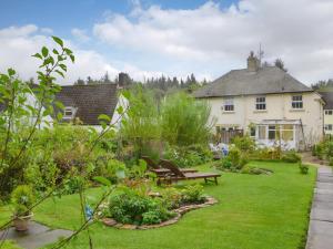 a garden in front of a house at Kielder Kip Cottage in Kielder