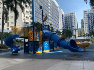a playground in a city with a slide at Moa staycation in Manila