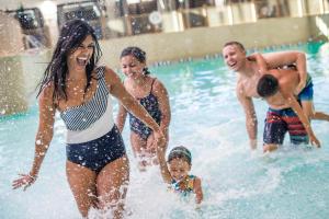 a group of people playing in a swimming pool at Great Wolf Lodge Sandusky in Sandusky